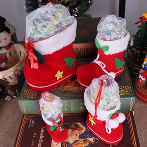 Detail of red flocked Christmas candy boots in four sizes with white faux fur and festive decor