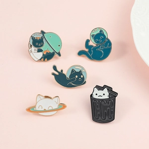 Detailed close-up of five colorful enamel cat astronaut badges on a soft pink background