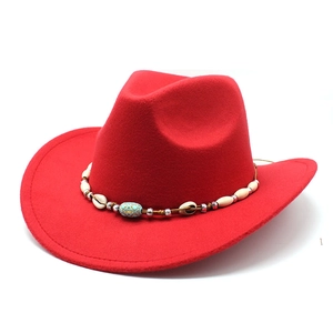 Macro shot of red felt cowboy hat with ethnic shell band and turquoise bead details