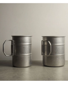Macro detail of camping cups with foldable handles in open and stored positions