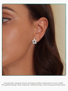 Close-up of minimalist s925 sterling silver hollow star hoop earrings worn on ear