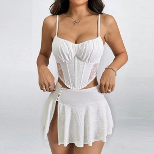 Detail of white lace patchwork camisole and high slit mini skirt set with satin finish