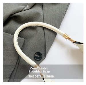 Detail of white leather round shoulder strap with premium gold metal swivel clasps