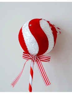 Detailed view of red flocked candy cane ornament with sequins and a striped bow decoration
