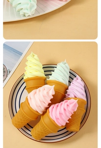 Detailed macro view of five colorful pastel artificial ice cream cones in a striped plate