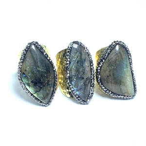 Three-piece gold hammered rings set featuring iridescent labradorite gemstones in blue hues