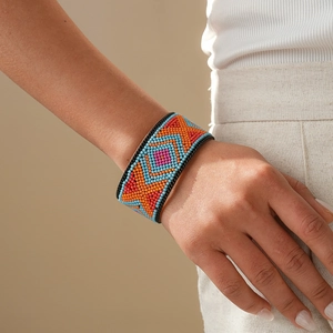 Detailed view of handmade bohemian beaded wide cuff bracelet with colorful geometric patterns