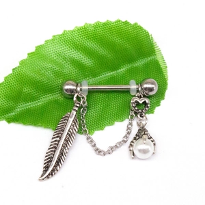 Detail of silver nipple ring featuring feather pendant and eagle claw holding a pearl