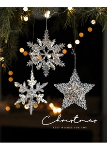 Close-up of transparent acrylic snowflake and star ornaments with glitter on a Christmas tree