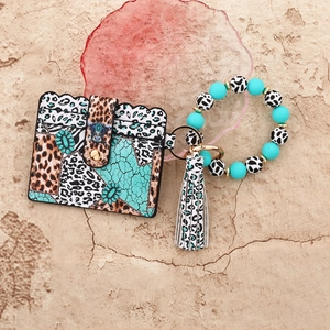 Detail of leopard print leather card holder with silicone bead wristlet and tassel