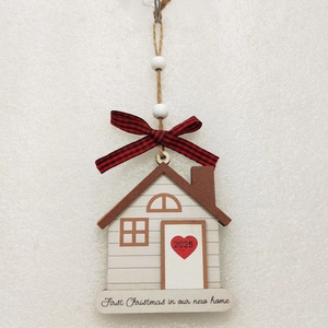 Detail of wooden house ornament with 2025 heart and New Home text for Christmas