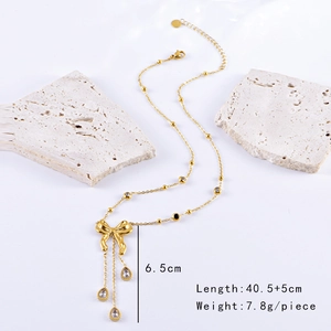 Detailed view of golden bow necklace with tassel water drop pendants and size specifications
