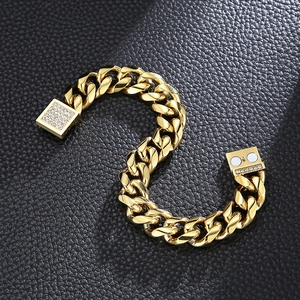 Detail of gold Cuban chain bracelet with a square diamond-set magnetic clasp on black leather