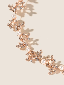 Detailed macro view of golden leaf bridal headpiece with sparkling crystals and pearls