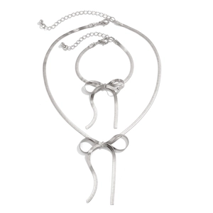 Flat silver snake chain necklace and bracelet set with central ribbon bow detail
