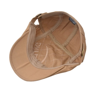 Detail showing the inner quilted lining and adjustable strap of the khaki newsboy cap