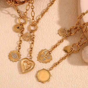 Detail of 18K gold-plated O-chain necklace with heart and starburst embossed pendants