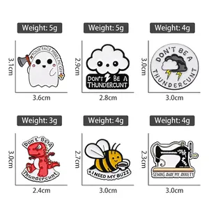 Set of creative enamel pins featuring cartoon ghost, dinosaur, and sewing machine designs