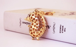 Detail of golden crystal hedgehog keychain featuring a heart-shaped hollow back design