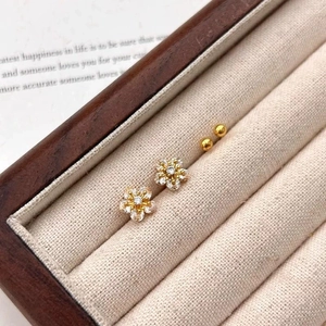 Sparkling zircon flower stud earrings set with gold beads in a premium jewelry box display