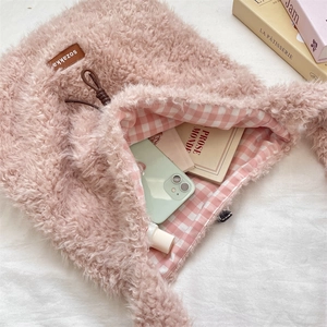 Pink faux shearling tote bag detail showing large capacity with plaid lining