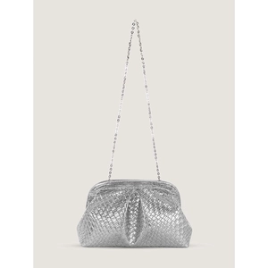 Macro detail of silver woven textured dumpling bag with sleek metal chain strap
