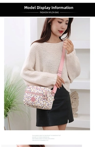 Detailed view of polka dot nylon crossbody bag with adjustable pink shoulder strap