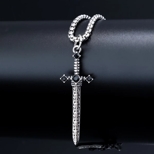 Macro shot of gothic sword pendant with black rhinestones on a stainless steel bead chain