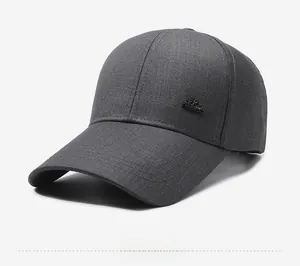 Detail view of dark grey baseball cap featuring a textured fabric and crown side metal buckle