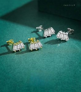 Macro view of S925 sterling silver geometric fan earrings with baguette-cut zircon