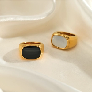 Polished gold stainless steel signet rings with black and white oval inlay accents