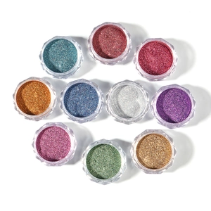 Sparkling nail glitter powder set in ten colorful faceted transparent jars on white background