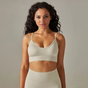 Detail of seamless ribbed sage green yoga bra featuring V-neck and thin shoulder straps