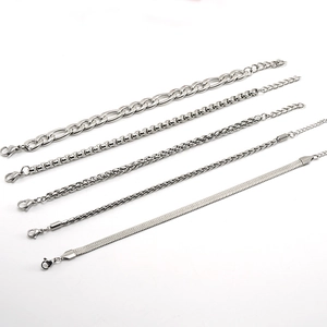 Detail of five different silver stainless steel chains including Figaro and snake link styles