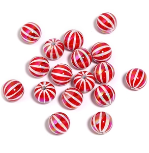 Macro shot of glossy red and white striped peppermint-style pumpkin beads for DIY jewelry