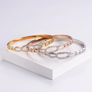 Interlocking oval bangle set in gold, rose gold and silver with shimmering pavé cubic zirconia