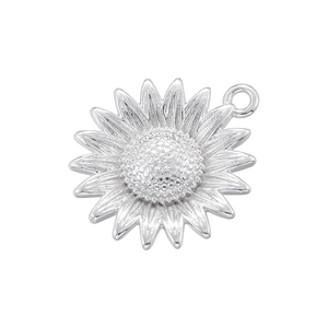 Macro detail of silver sunflower pendant showing intricate petal texture and metallic luster