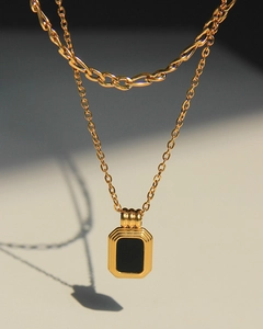 Detailed macro view of vintage double-layer necklace with square black pendant