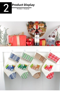 Detail of four knit Christmas stockings with train embroidery hanging on a fireplace mantel