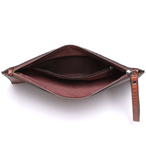 Brown snakeskin textured envelope clutch showing interior red lining and zipper pocket