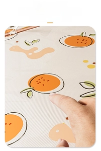Macro detail of breathable mesh laundry bag featuring orange fruit prints and pink zipper