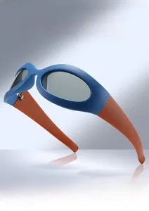 Detail view of cat eye polarized sunglasses with navy frame and vibrant orange temples