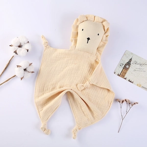 Detail of baby lion comforter blanket with soft knotted corners and cotton textures