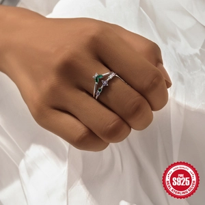 S925 sterling silver flower ring with green and purple zircon gemstones on model's finger