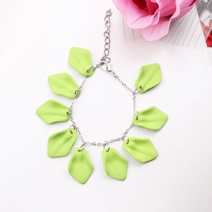 Detail of silver chain bracelet with light green leaf pendants and lobster clasp