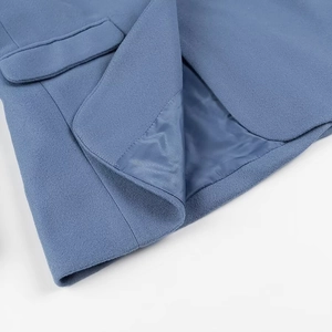 Detailed close-up of blue wool fabric texture, precise stitching and premium inner lining