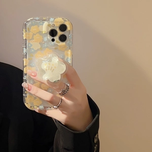 Detail of transparent iPhone case with yellow floral patterns and flower grip stand