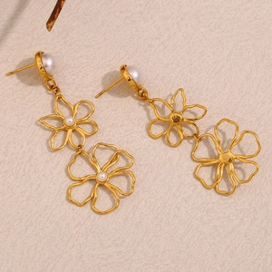 Macro detail of 18K gold plated floral earrings with white pearls and hollow petals