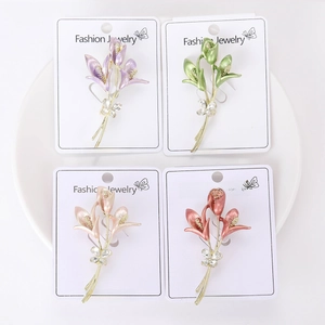 Detail of four floral enamel brooches with rhinestones and pearlescent finish