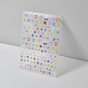 Detailed view of colorful 3D embossed nail stickers with cakes and birthday motifs